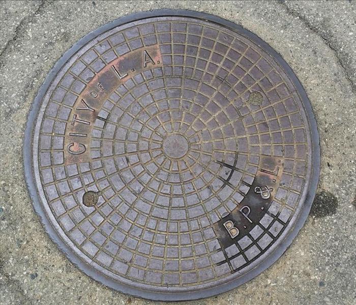 manhole cover, metal grate in ground
