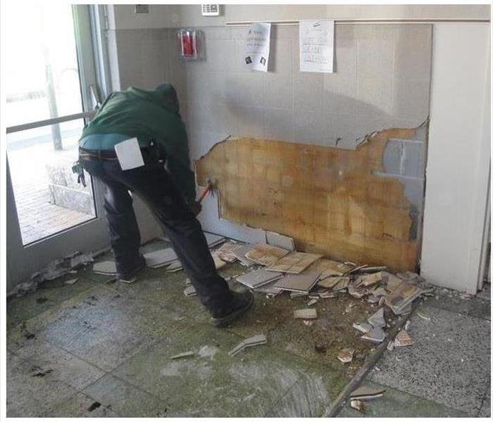 SERVPRO employee cleaning damage